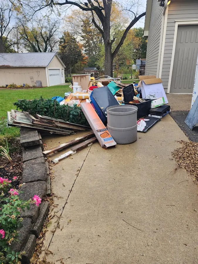 Dumpster being loaded with debris for Estate Cleanout Dumpster Rental in August